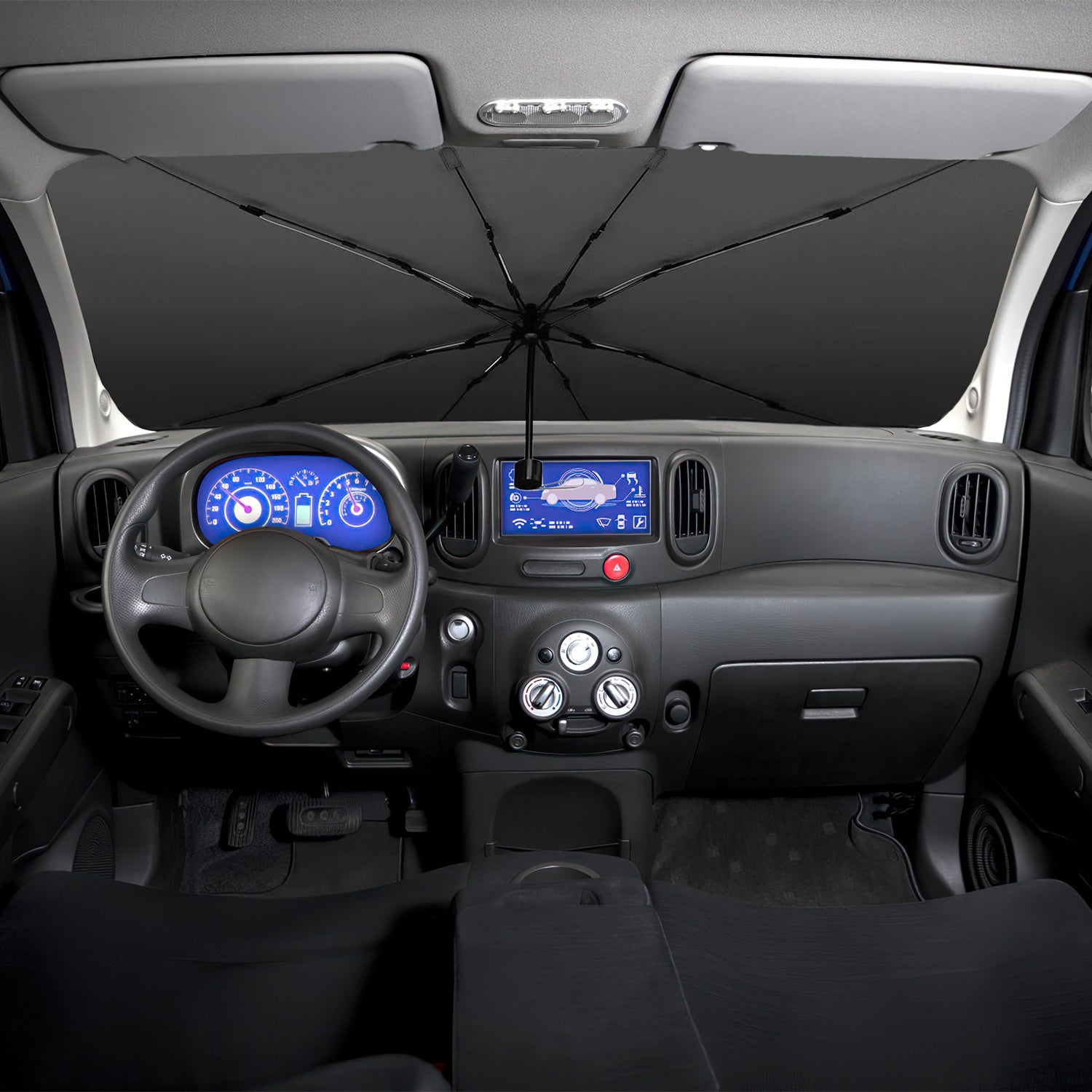 Car interior with a black umbrella covering the windshield